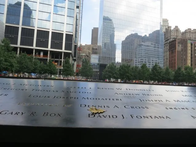 The September 11 Memorial. Just as this photo was taken, a leaf drifted from the sky to the inscription for Brooklyn fire fighter David J. Fontana. Fontana and 14 other from his squad perished when the south tower collapsed after they had climbed up 
