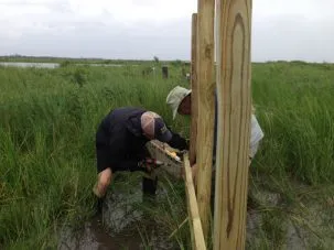 Keith and Tim screwing the framing onto the structure after sinking the posts.