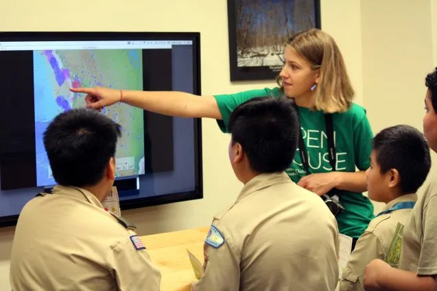 Anna Barth and a group of Boy Scouts looked for patterns in earthquake locations and sizes by watching years of eruptions compressed into a few minutes. The video they're watching is part of the Seismic Sound Lab's SeismoDome project.