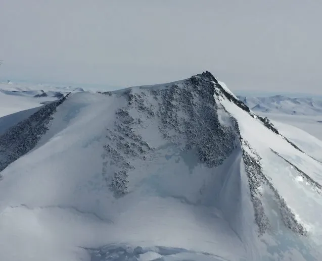 A snow covered mountain peak in the Antarctic Peninsula reaches skyward some 7000 ft. into the air. (Photo M. Turrin)