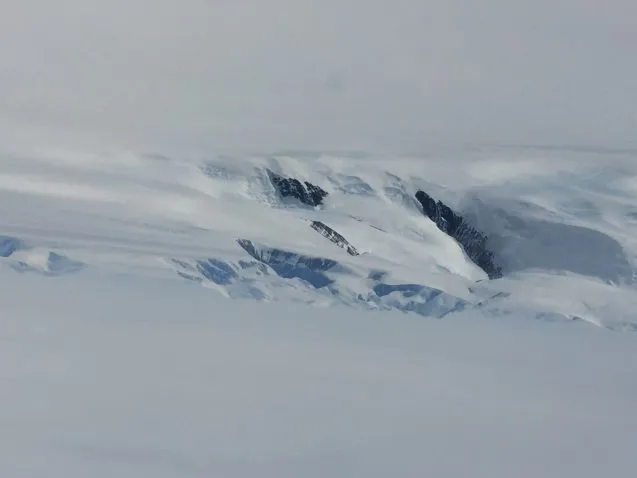 The ice on the Antarctic Peninsula spills from high mountains down to flat reaches of ice and then into ice shelves that buffer the edges from the ocean water. (Photo: M. Turrin)