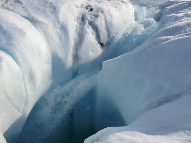 Meltwater from the Greenland ice sheet can travel through channels to reach bedrock; a new study shows where the water goes. Here, water plunges down a moulin, or hole in the ice. Photo: Marco Tedesco/Lamont-Doherty Earth Observatory