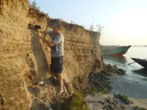 I am hammering our iron pipe into the eroding cut bank to collect a sample without exposing the center of it to light so it can be use for OSL dating.