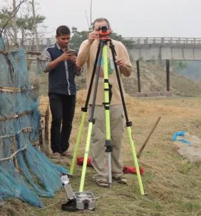 Me sighting through the optical level to get the relative elevations of the 6 optical fiber compaction wells.