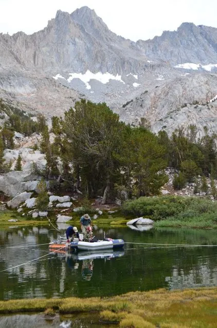 Scott Mensing from the University of Nevada-Reno works with undergraduate students Austin Bassett and Scott Wright to take sediment cores from one of the Baboon Lakes.
