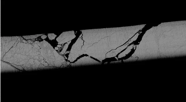 Ice threaded with leads of open water that show up dark black against the white ice. These dark areas absorb energy from the sun causing a feedback loop. 