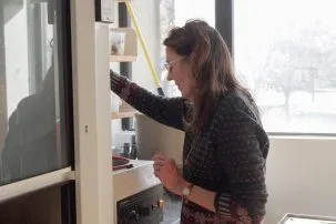 Dorothy Peteet standing in her lab next to the fume hood.