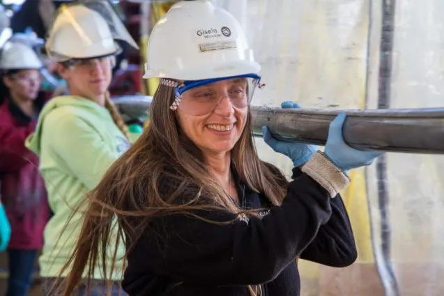Gisela Winckler Carrying Sediment Core on Catwalk of Joides Resolution credit Tim Fulton IODP 887x591 1 637x424.jpg